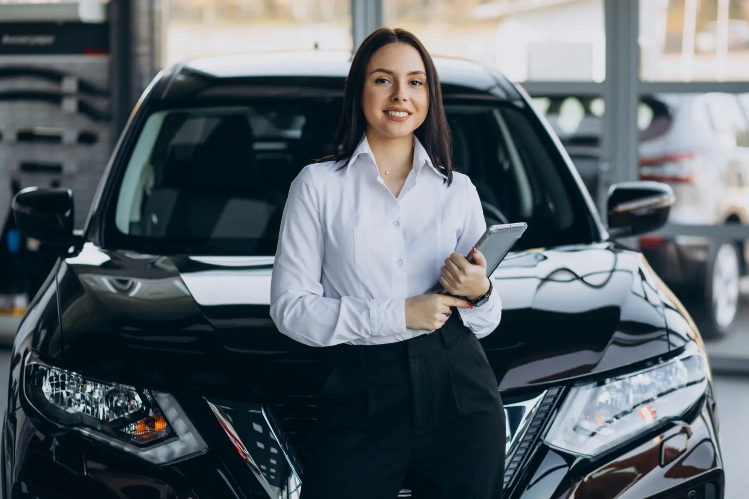 Vendedora em showroom de veículos com diversos tipos de carros